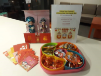 Colourful candy box, red packets and Chinese opera dolls.
